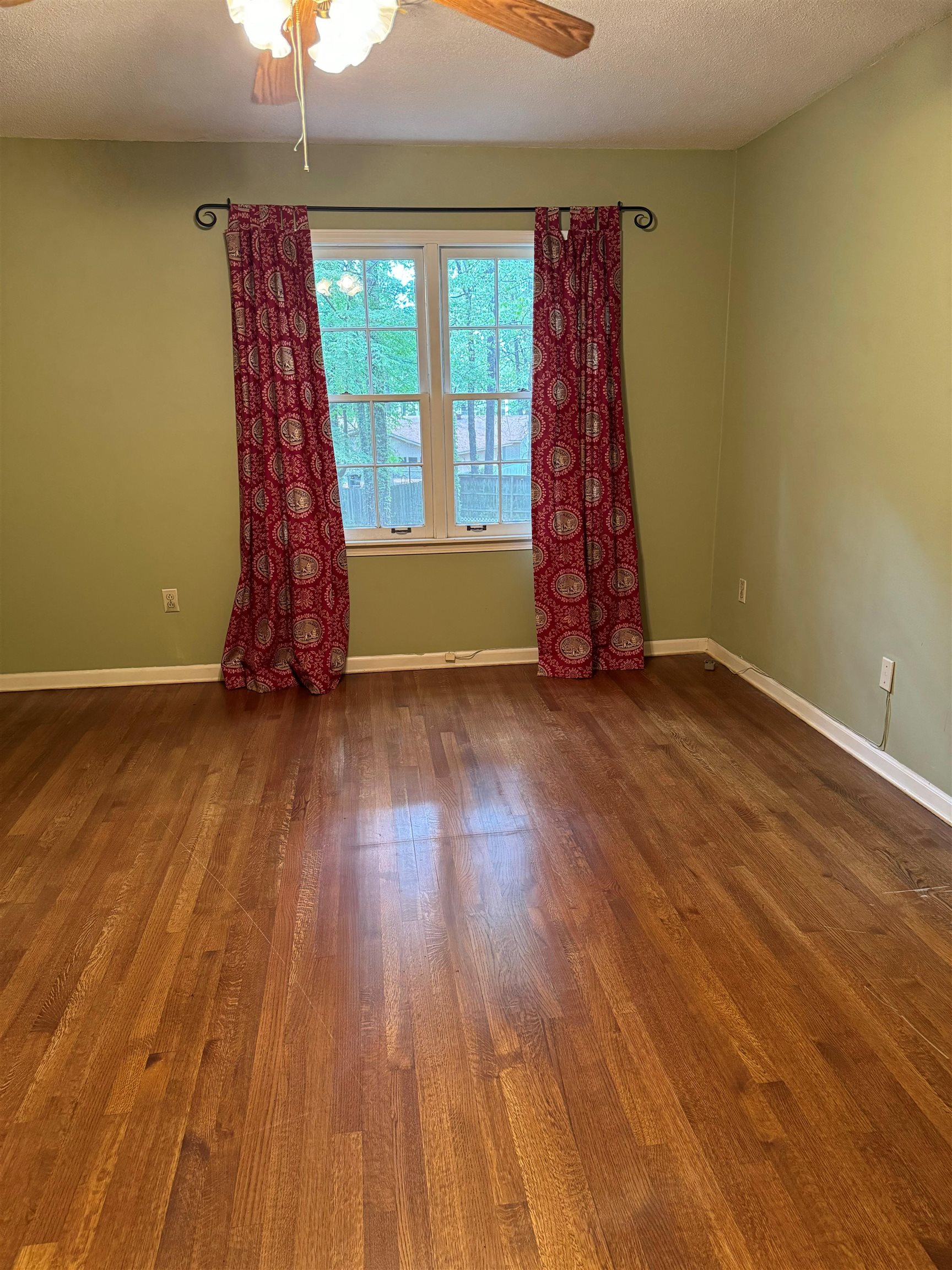 6738 River Birch Road Memphis, TN 38119 - Photo 14 of 17 Unfurnished room with a textured ceiling, ceiling fan, and dark hardwood / wood-style floors