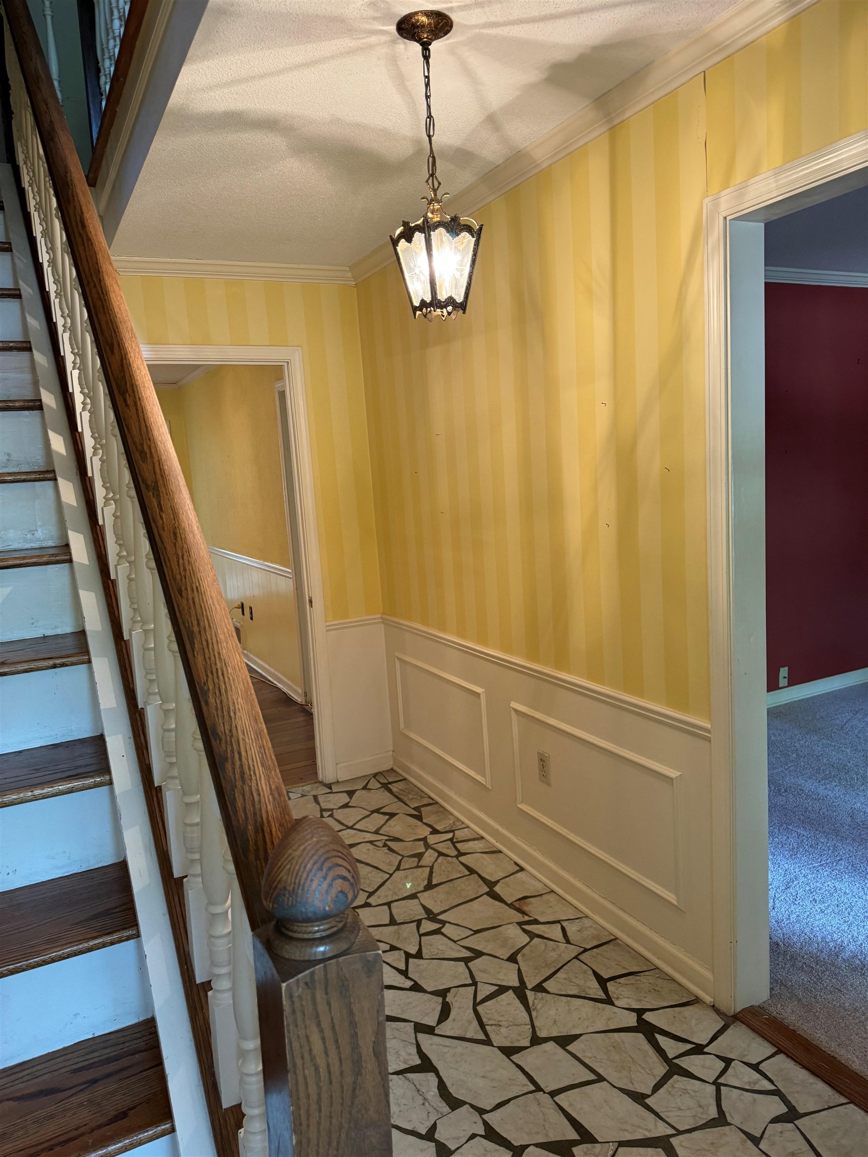 6738 River Birch Road Memphis, TN 38119 - Photo 6 of 17 Interior space featuring ornamental molding, a textured ceiling, a notable chandelier, and carpet