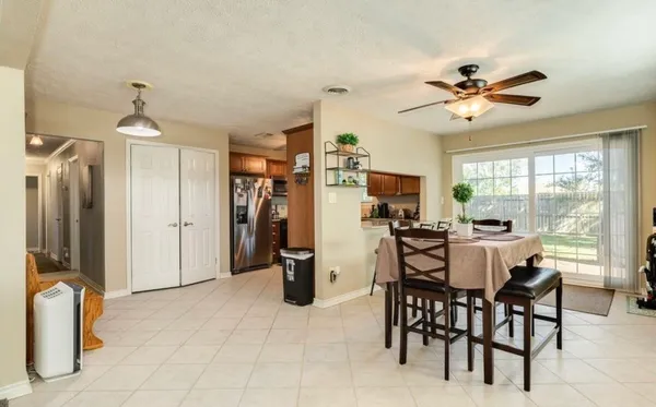 a view of a dining room with furniture and a chandelier