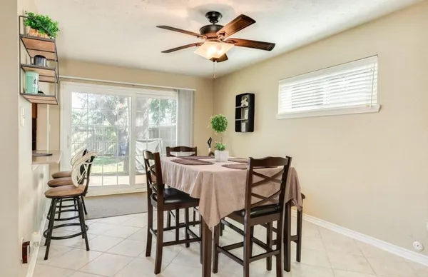 a dining room with furniture and window