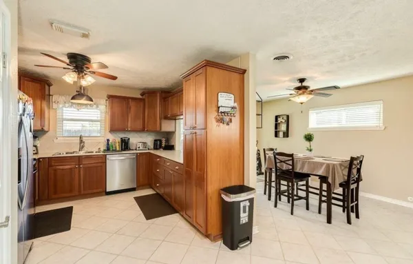 a kitchen with granite countertop appliances cabinets and furniture