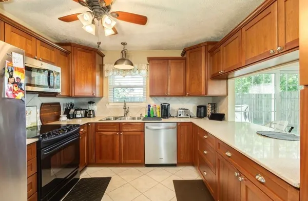 a kitchen with stainless steel appliances granite countertop a stove sink and cabinets