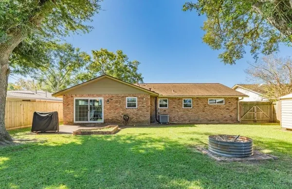 a front view of a house with a garden and yard