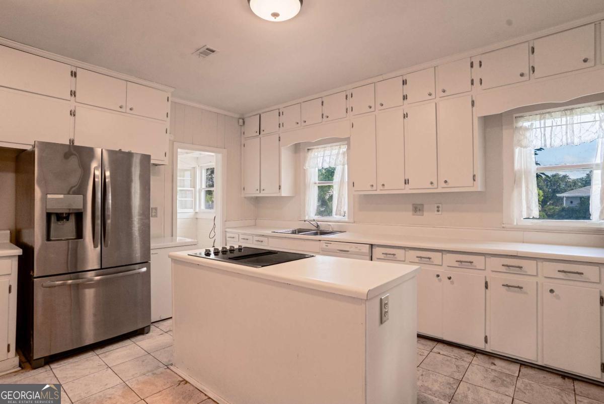 316 Fair Street Baxley, GA 31513 - Photo 11 of 64 a kitchen with appliances a sink and a counter top space