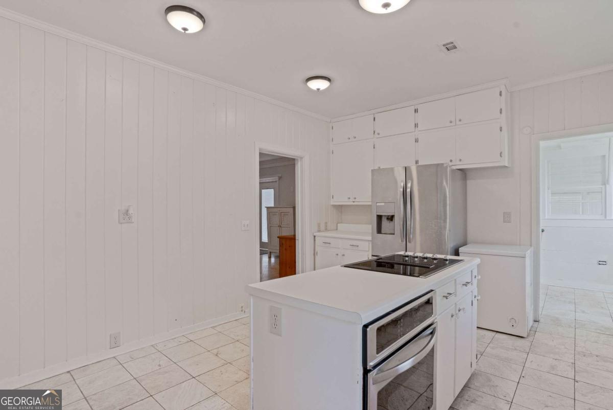 316 Fair Street Baxley, GA 31513 - Photo 12 of 64 a kitchen with stainless steel appliances a refrigerator and a stove