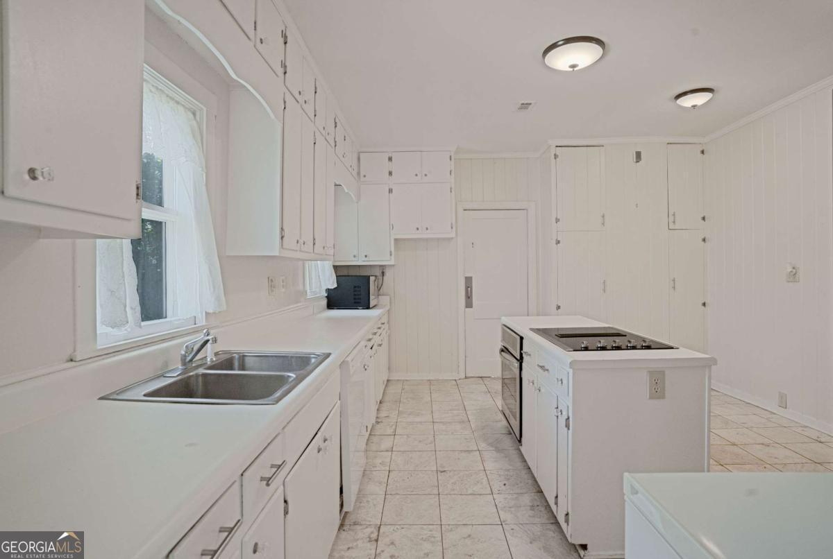 316 Fair Street Baxley, GA 31513 - Photo 13 of 64 a kitchen that has a sink and a stove
