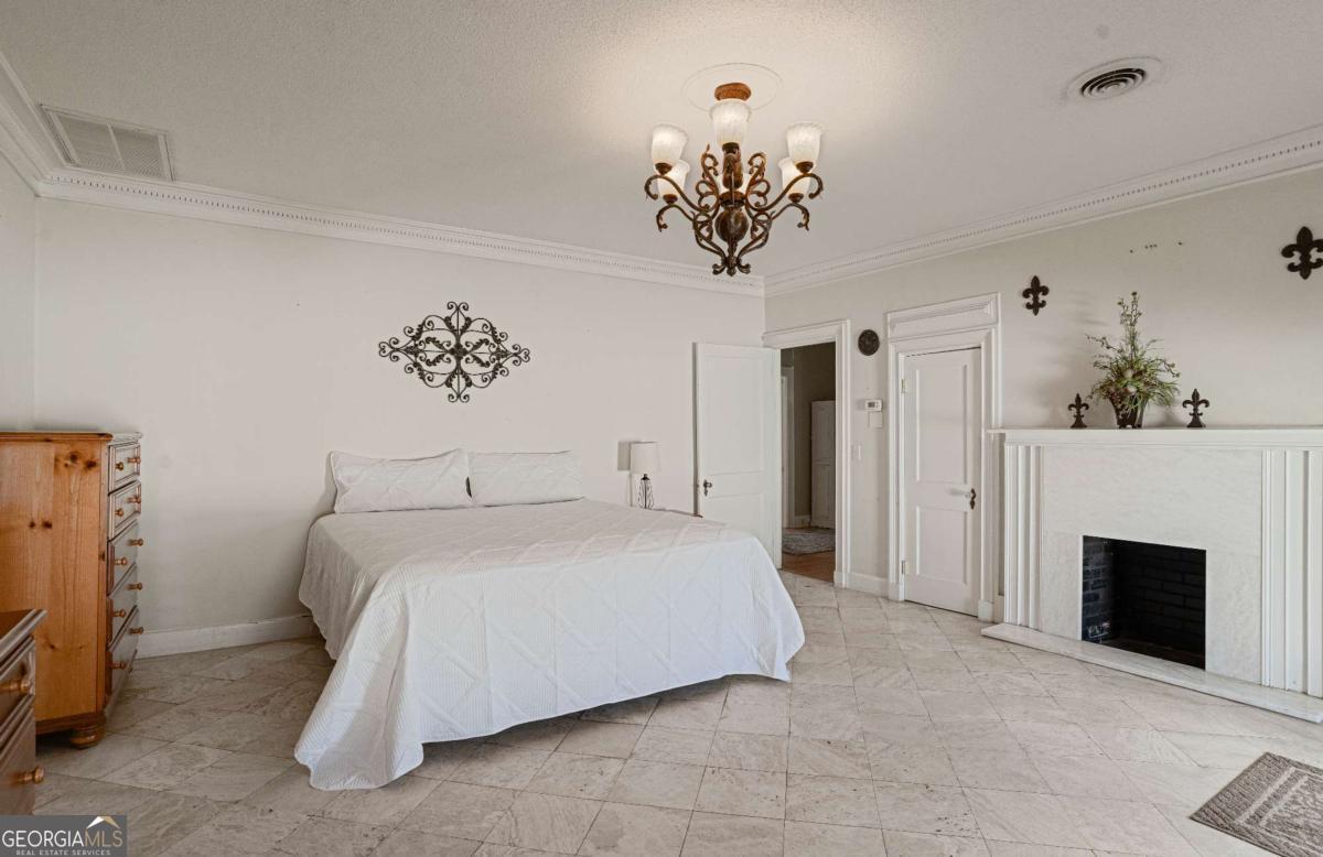 316 Fair Street Baxley, GA 31513 - Photo 14 of 64 a bedroom with a bed and a fireplace
