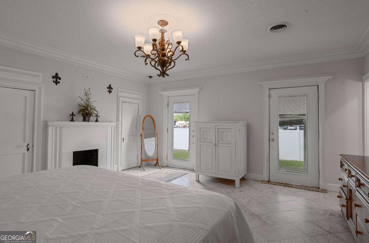 316 Fair Street Baxley, GA 31513 - Photo 16 of 64 a bedroom with a bed and a fireplace