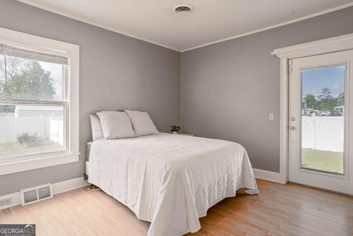 316 Fair Street Baxley, GA 31513 - Photo 23 of 64 a bedroom with a bed and a large window