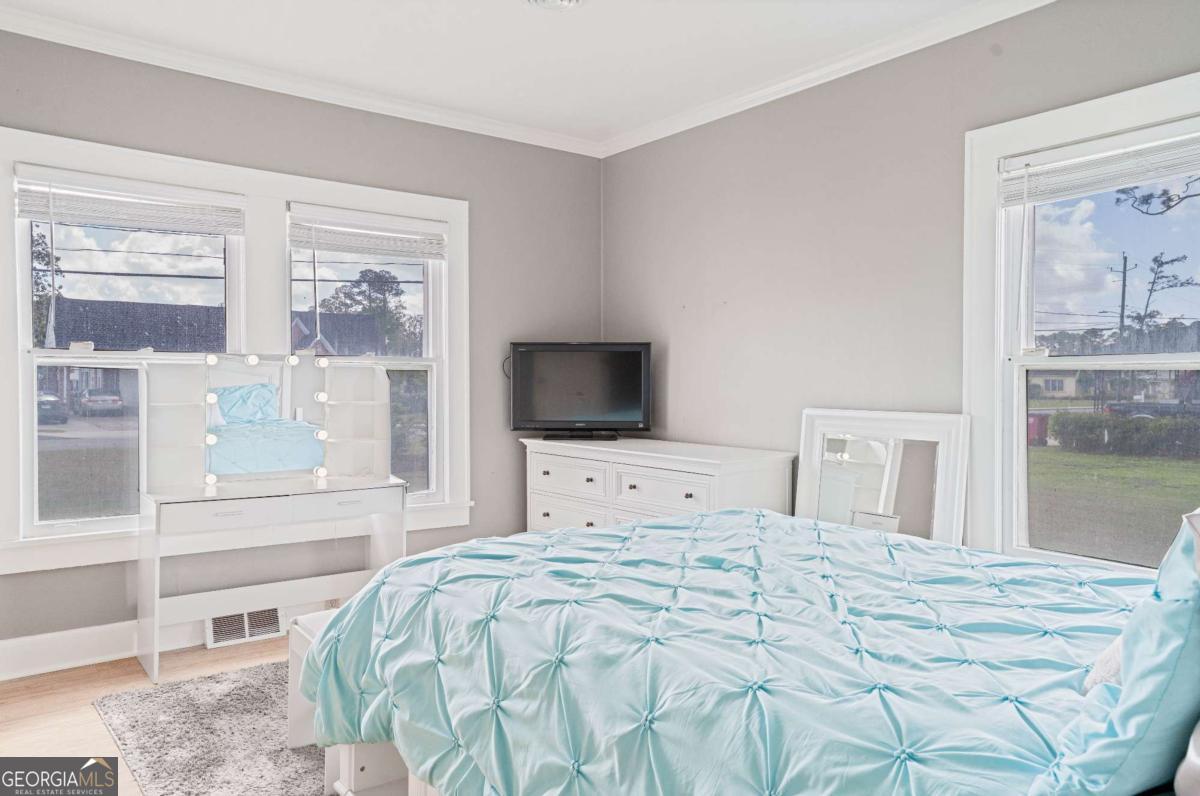 316 Fair Street Baxley, GA 31513 - Photo 27 of 64 a bedroom with a large bed and a window