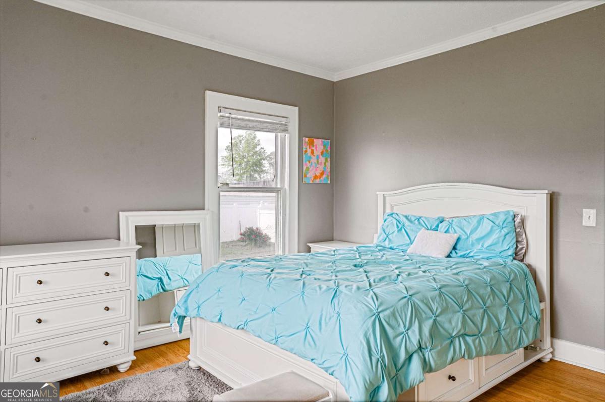 316 Fair Street Baxley, GA 31513 - Photo 28 of 64 a bedroom with a bed and a window