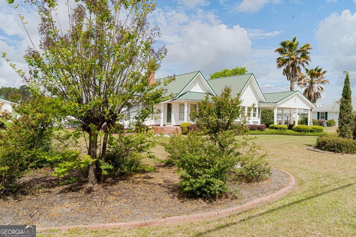 316 Fair Street Baxley, GA 31513 - Photo 40 of 64 a front view of a house with a garden