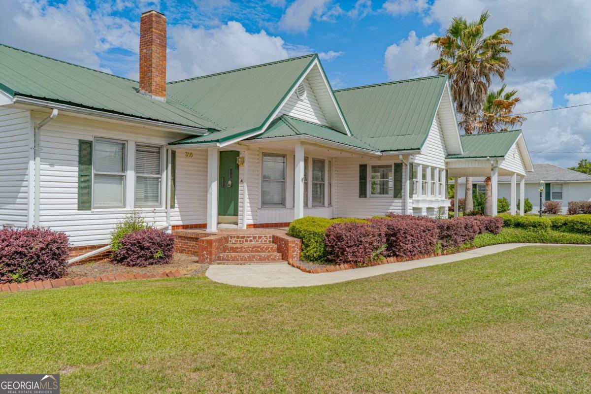 316 Fair Street Baxley, GA 31513 - Photo 41 of 64 a front view of a house with garden
