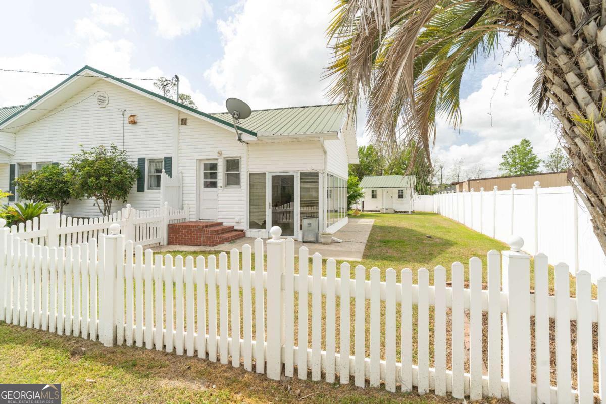 316 Fair Street Baxley, GA 31513 - Photo 45 of 64 a view of a house with wooden fence next to a yard