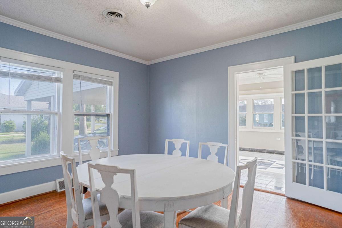 316 Fair Street Baxley, GA 31513 - Photo 6 of 64 a view of a dining room with furniture and wooden floor