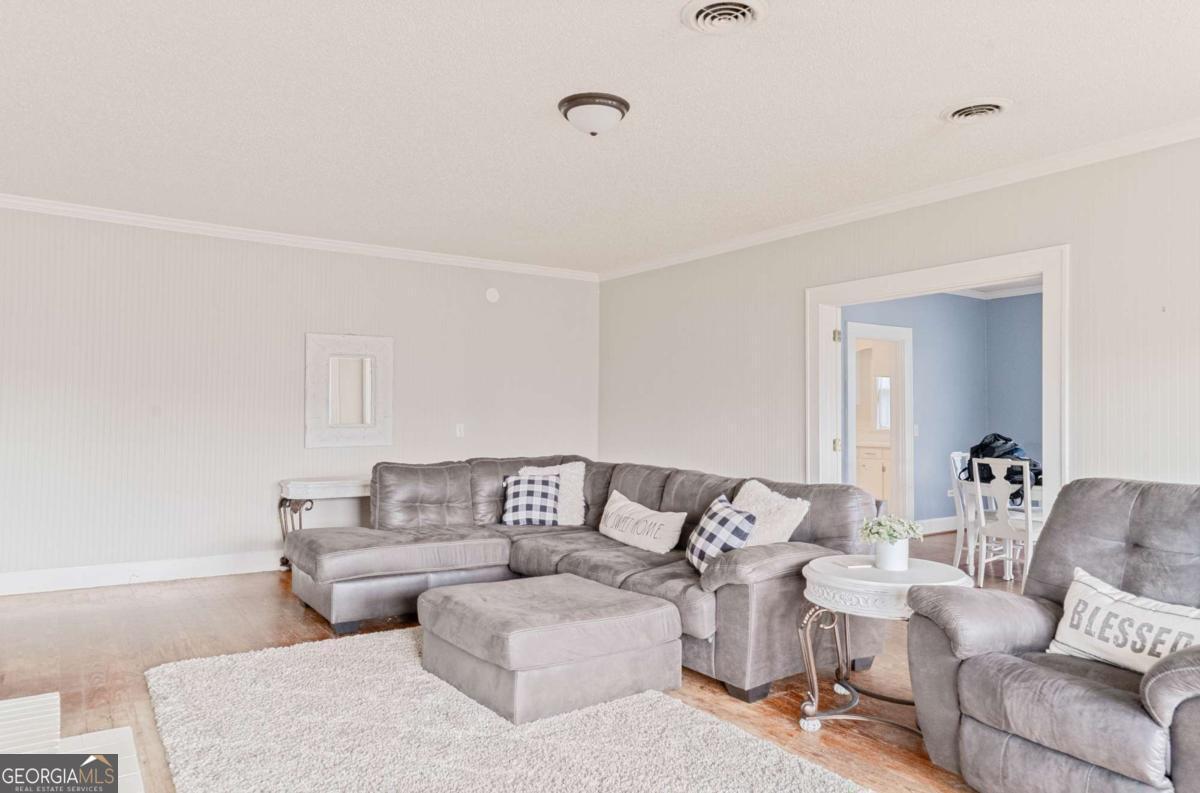 316 Fair Street Baxley, GA 31513 - Photo 8 of 64 a living room with furniture and white walls