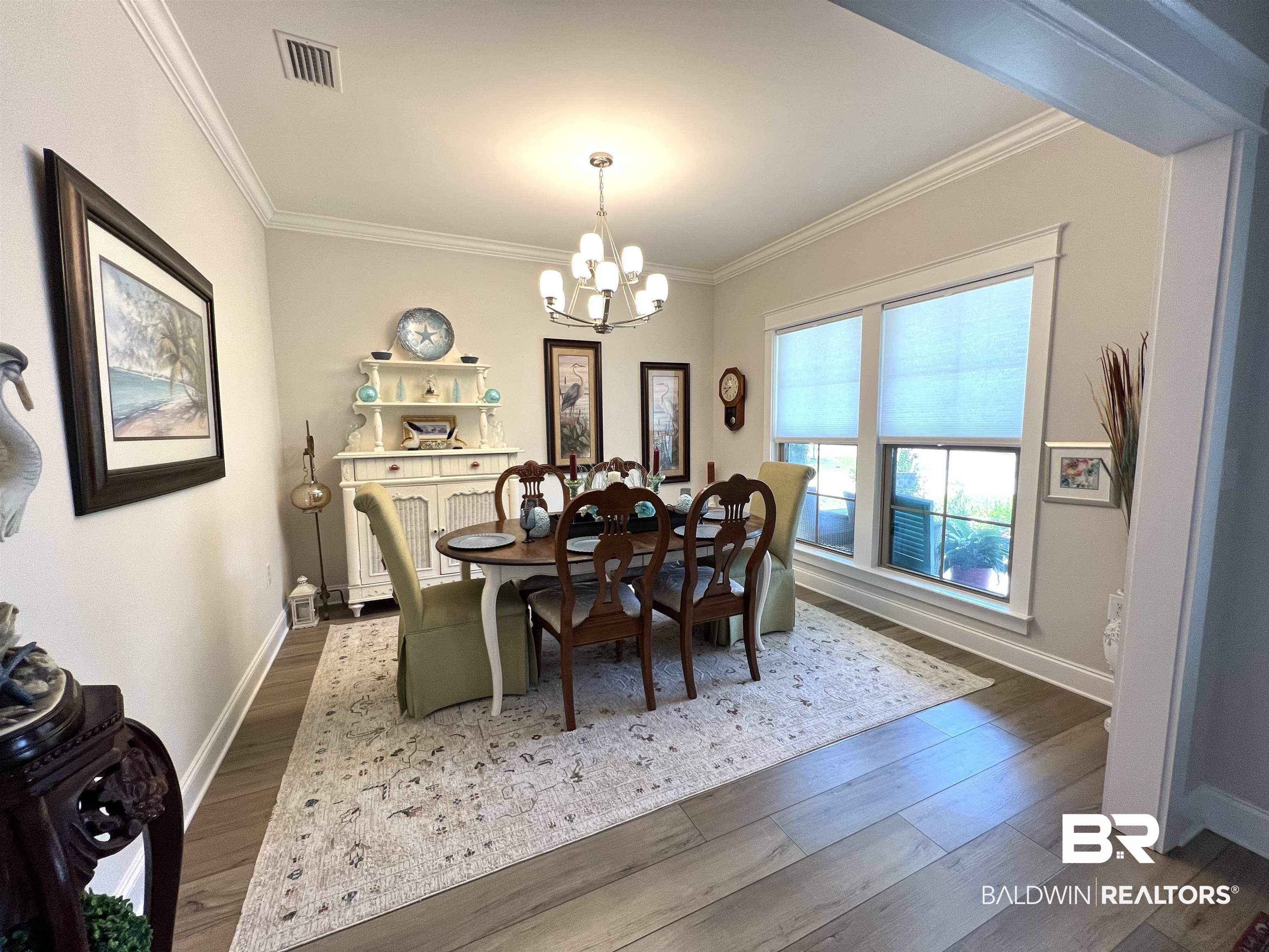 1653 Hudson Road Foley, AL 36535 - Photo 5 of 31 Dining room with crown molding, dark hardwood / wood-style flooring, and a notable chandelier