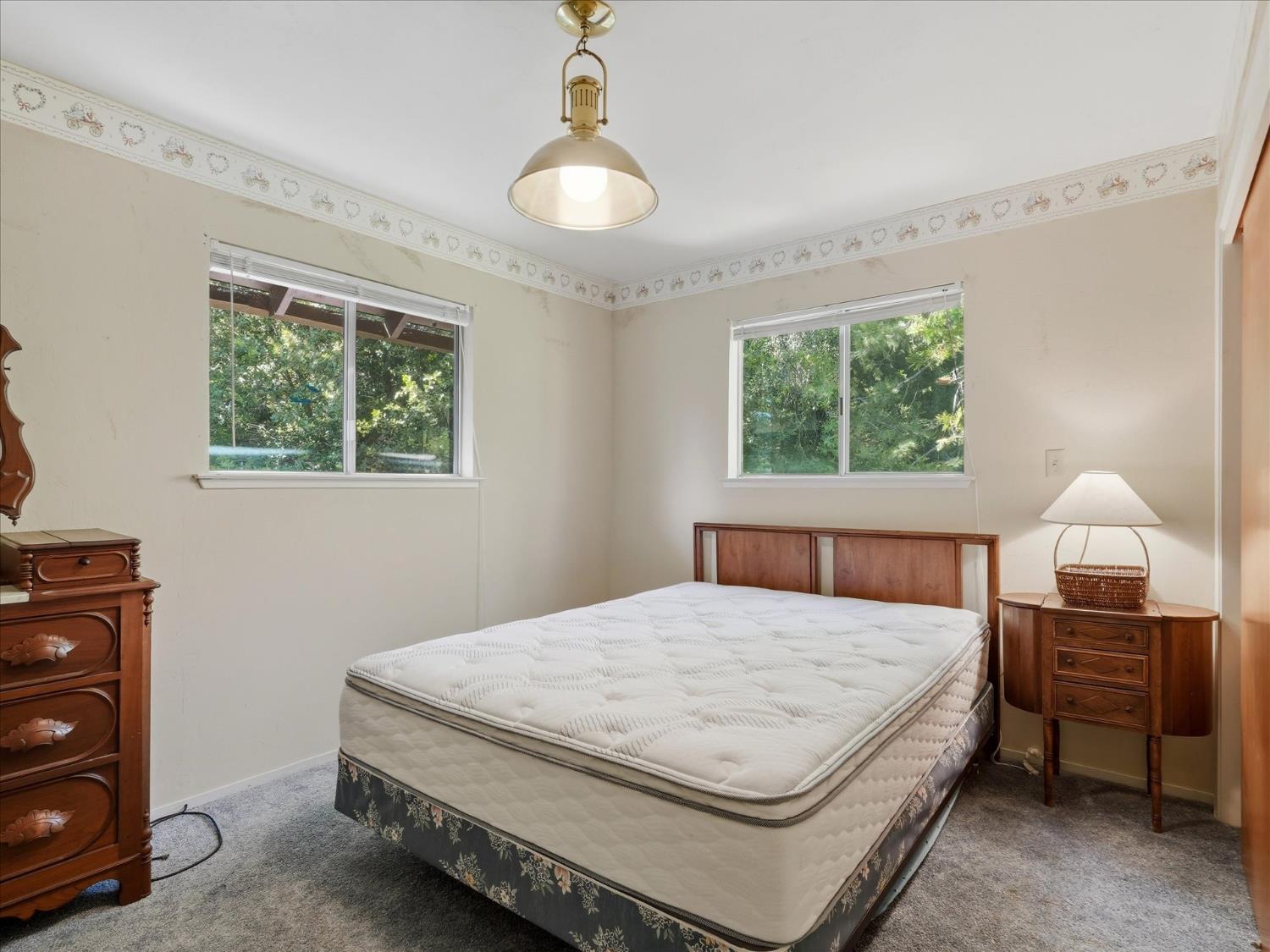 45167 Tolladay Road Oakhurst, CA 93644 - Photo 22 of 50 a bedroom with a bed and a window