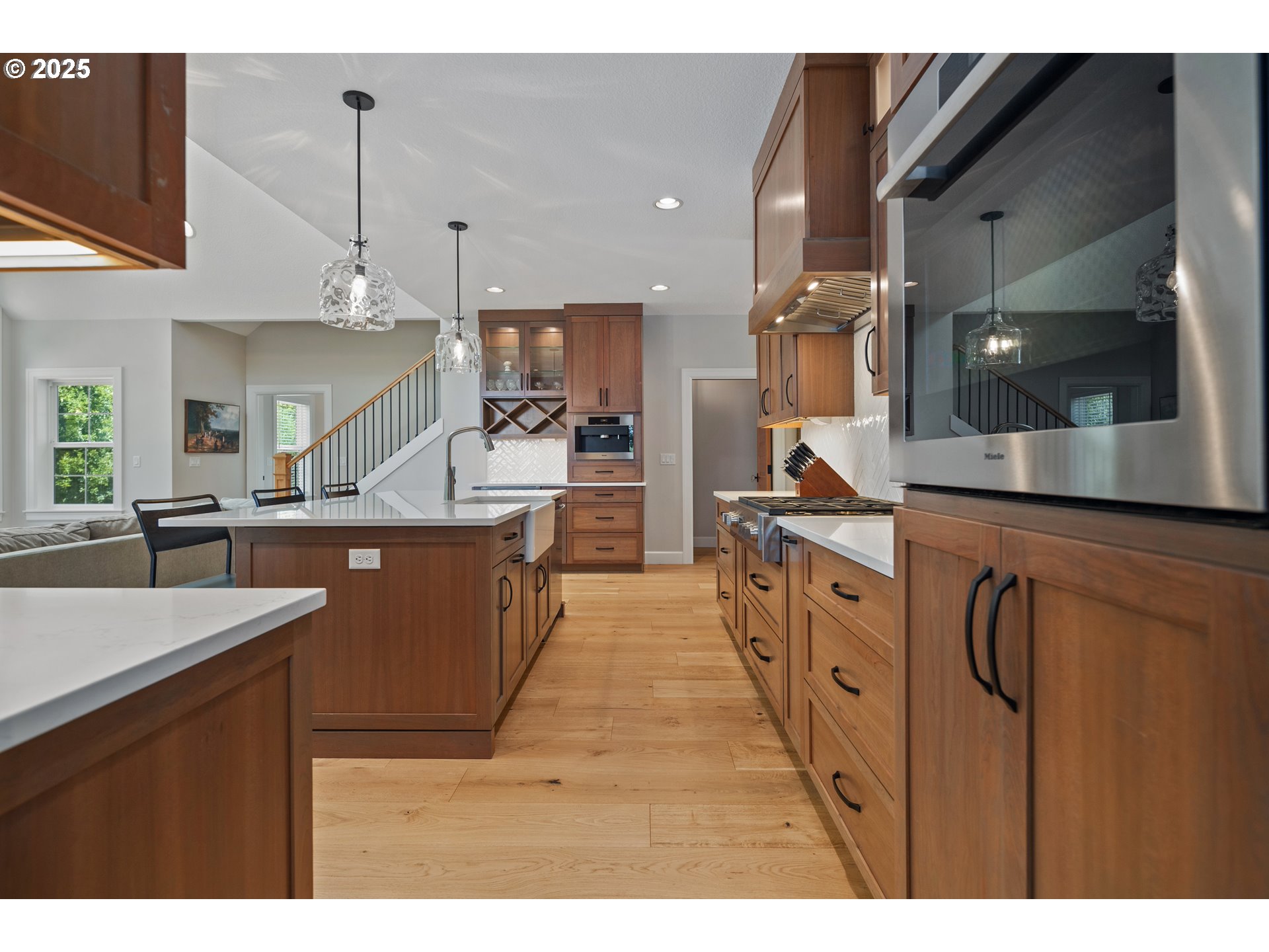 451 South Wilda Road West Linn, OR 97068 - Photo 12 of 47 a large kitchen with kitchen island a large counter top space a sink stainless steel appliances and cabinets