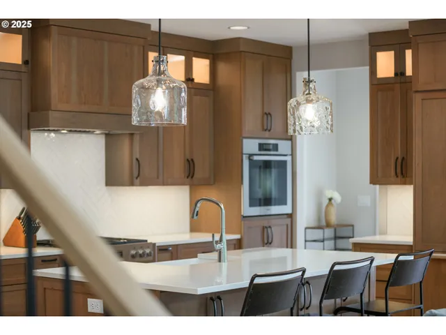 a kitchen with cabinets and chandelier