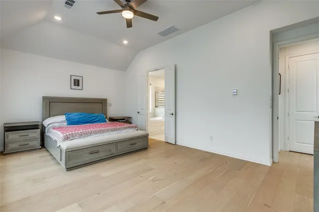 a bedroom with a bed and a ceiling fan