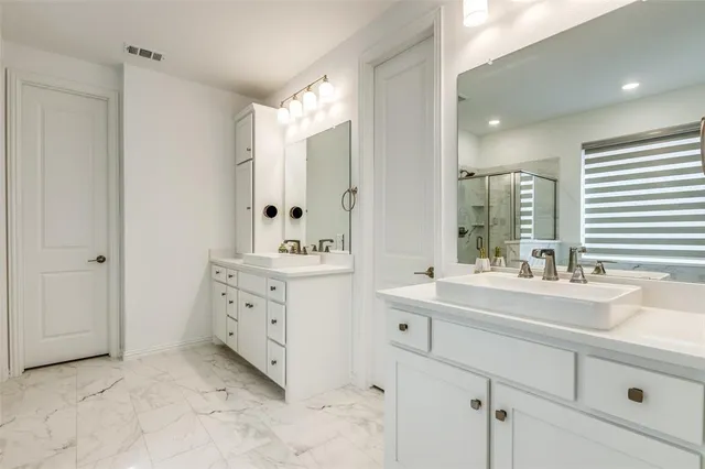 a bathroom with a sink vanity and mirror