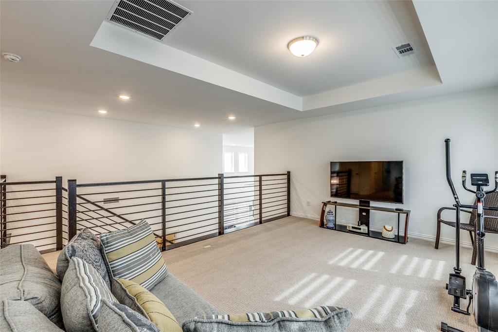 1631 Prairie Clover Road Prosper, TX 75078 - Photo 22 of 32 a view of a livingroom with furniture and a flat screen tv