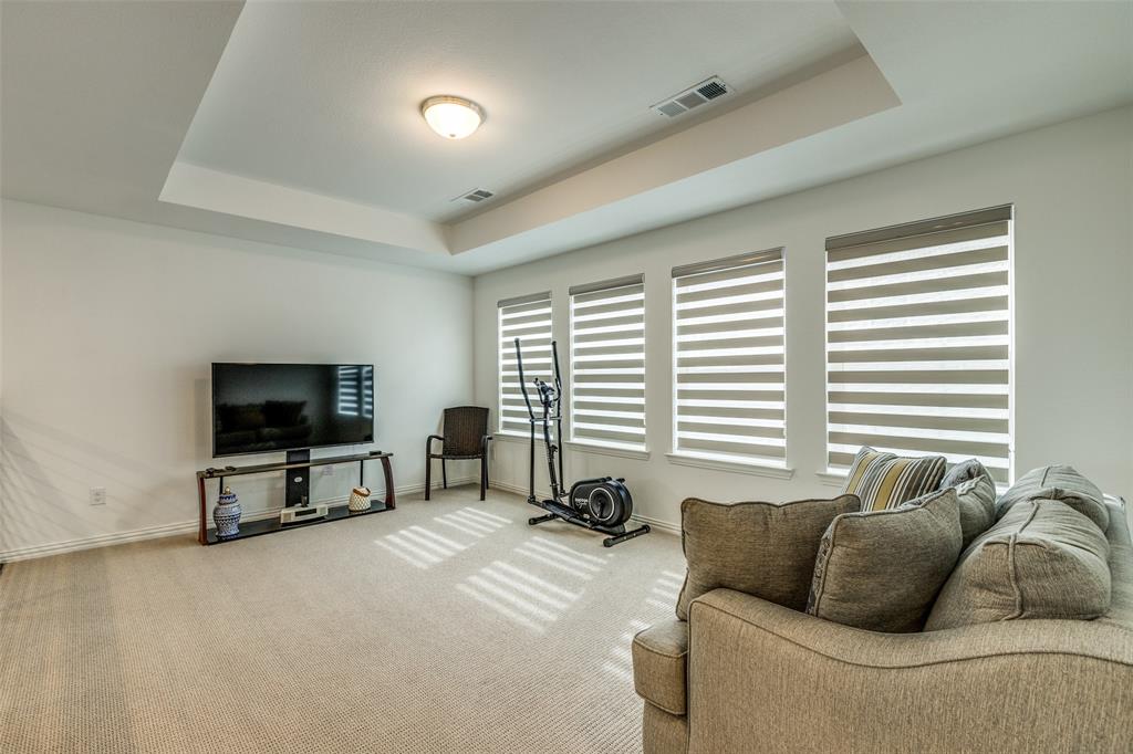 1631 Prairie Clover Road Prosper, TX 75078 - Photo 23 of 32 a living room with furniture and a flat screen tv