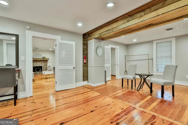 a bedroom with furniture and a wooden floor