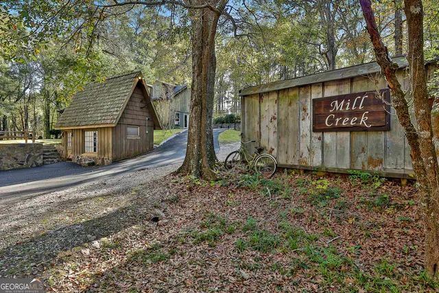a view of a house with a yard and wooden fence
