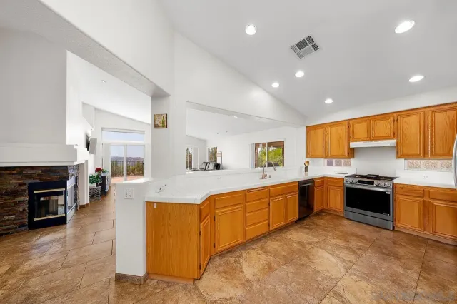 a large kitchen with stainless steel appliances granite countertop lots of counter top space