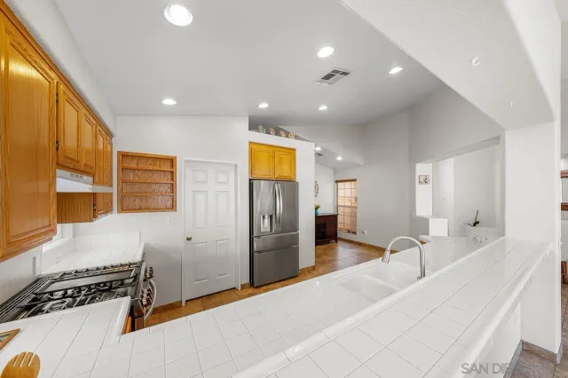 a lobby with a couch and a refrigerator