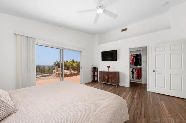 a bedroom with a bed and a flat tv screen