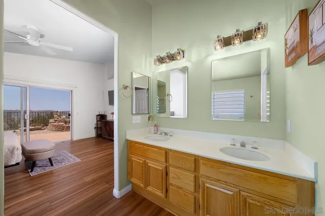 a bathroom with a granite countertop sink mirror and toilet