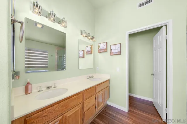 a bathroom with a sink a mirror and a window