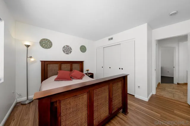 a bedroom with a bed and a dresser