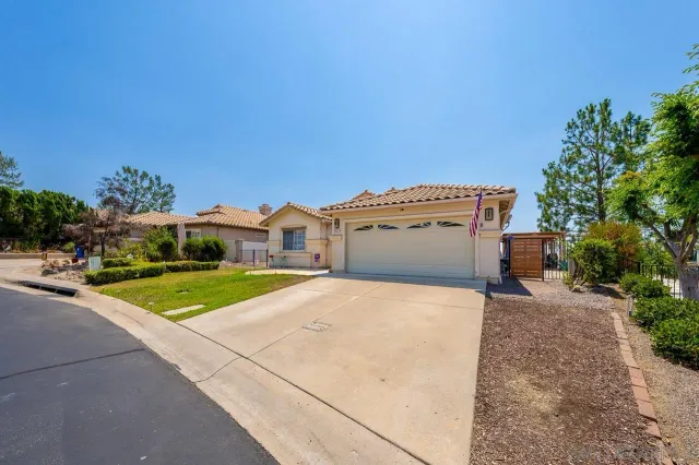 a view of a house with backyard and garage