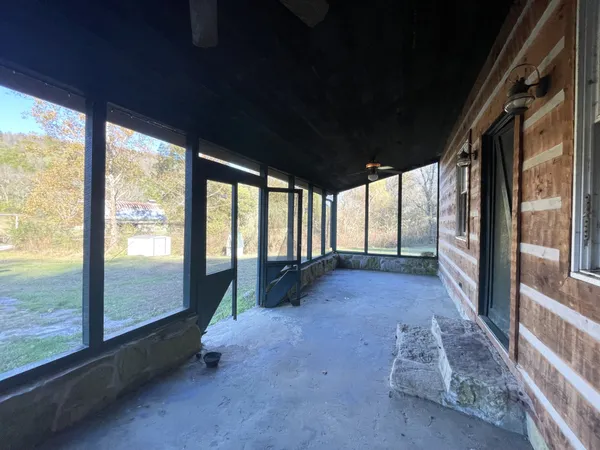 a view of a porch with wooden floor and outdoor space