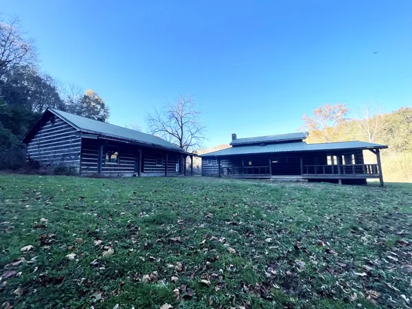 a view of a backyard with wooden fence
