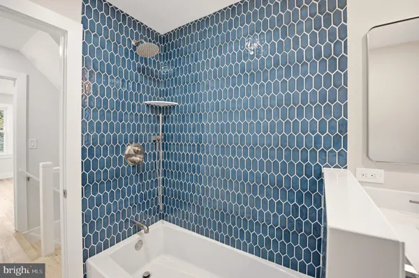 a bathroom with a bathtub and shower