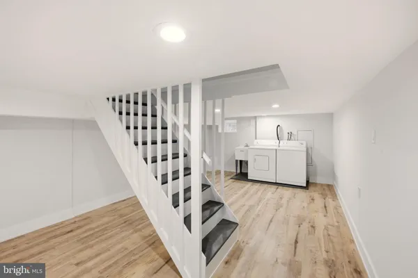 a view of a room with wooden floor and stairs