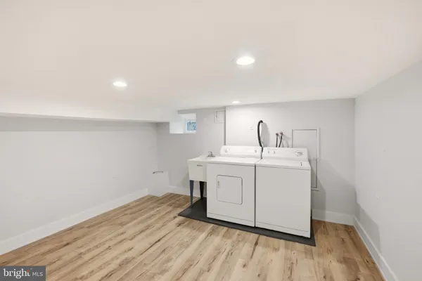 a utility room with a sink washer and dryer