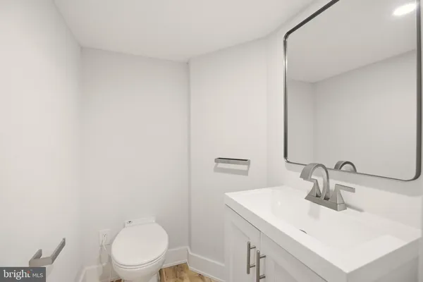 a bathroom with a sink toilet and vanity