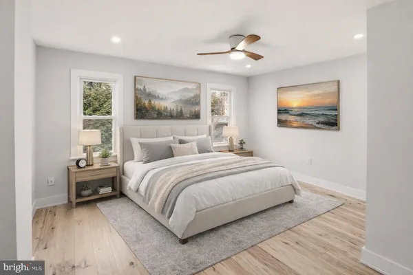 a bedroom with a large bed and a painting on the wall