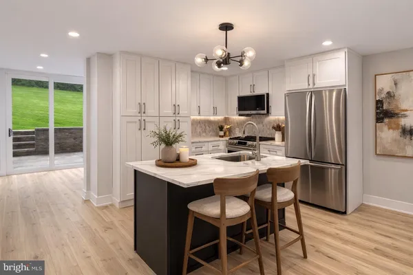 a kitchen with stainless steel appliances a dining table chairs and chandelier