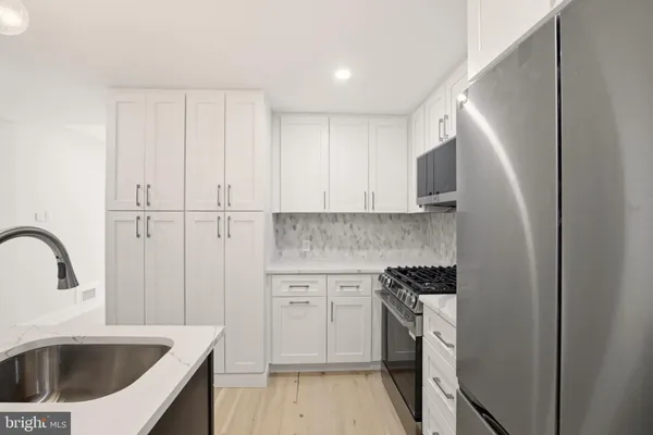 a kitchen with a sink cabinets and stainless steel appliances