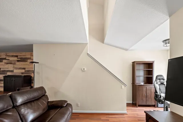 a view of living room with furniture and wooden floor