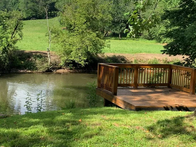 a view of a wooden deck with a yard