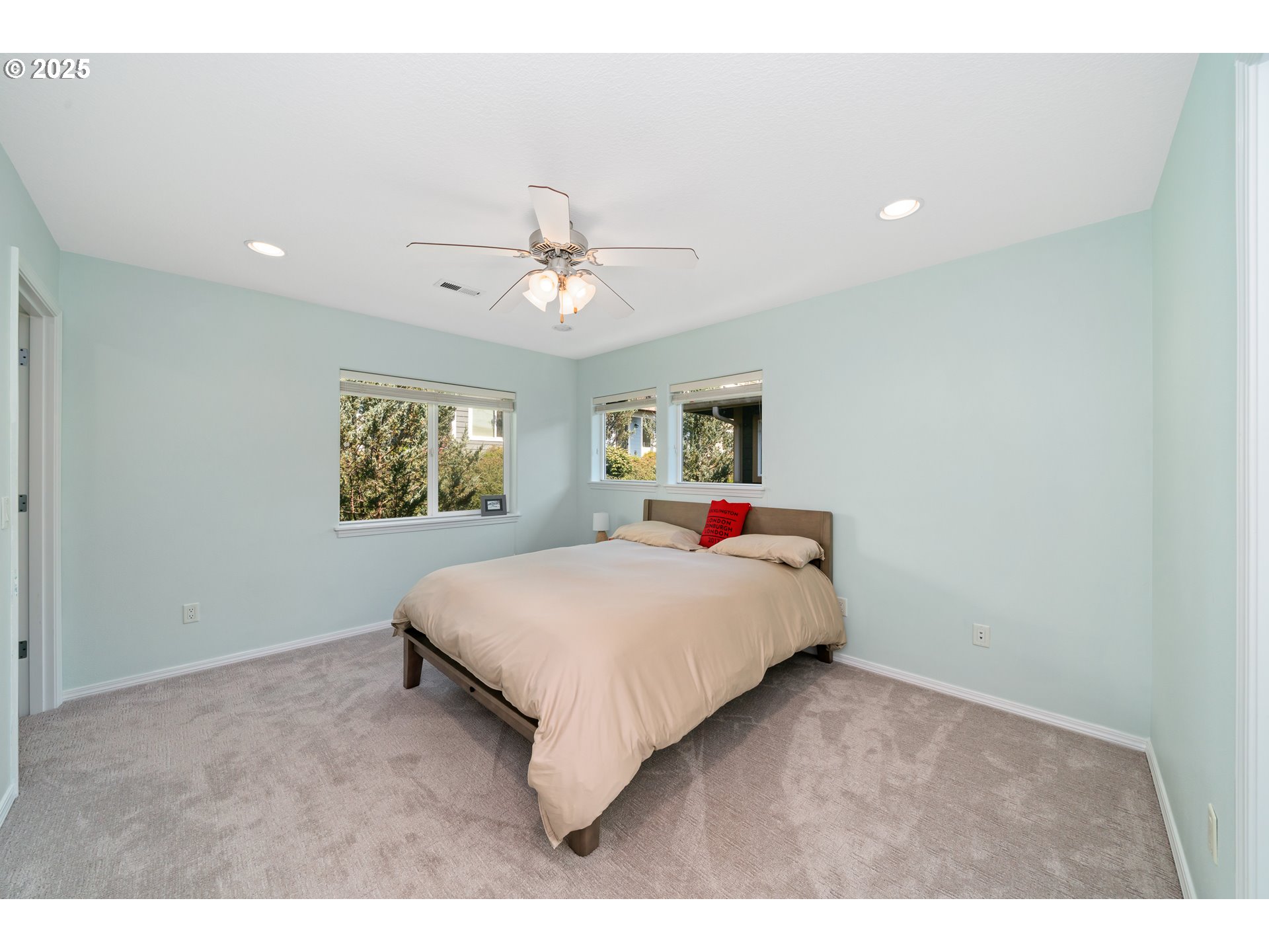 13150 D Street, Unit 12 Nehalem, OR 97131 - Photo 23 of 40 a spacious bedroom with a bed and a chandelier