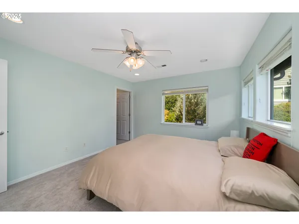 a bedroom with a large bed and a window